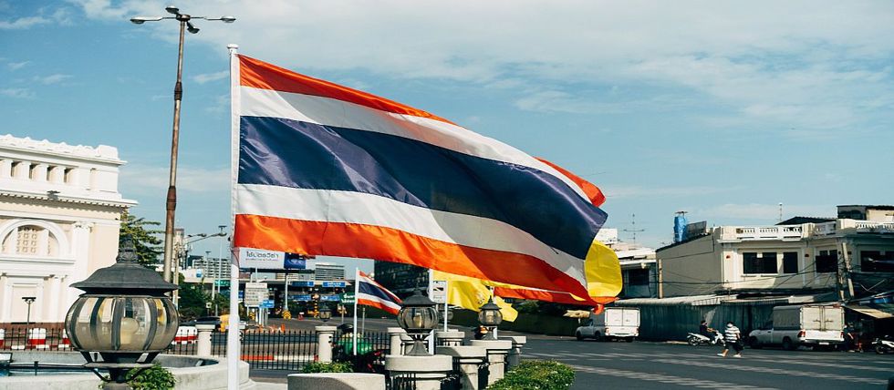 Thailand's flag flying over an intersection