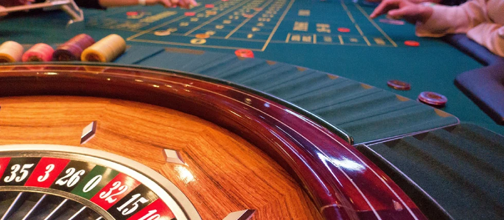 People betting on roulette at a casino table. Fake Mexican Casino Ponzi Scheme