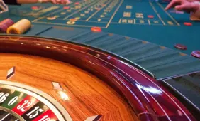 People betting on roulette at a casino table. Fake Mexican Casino Ponzi Scheme